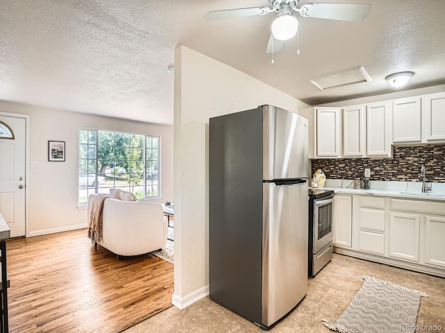 3304 W 3rd Ave, Denver, CO 80219 - kitchen featuring appliances with stainless steel finishes, a textured ceiling, light countertops, a ceiling fan, and tasteful backsplash
