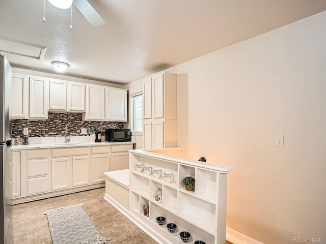 3304 W 3rd Ave, Denver, CO 80219 - kitchen featuring black microwave, backsplash, light countertops, a ceiling fan, and freestanding refrigerator
