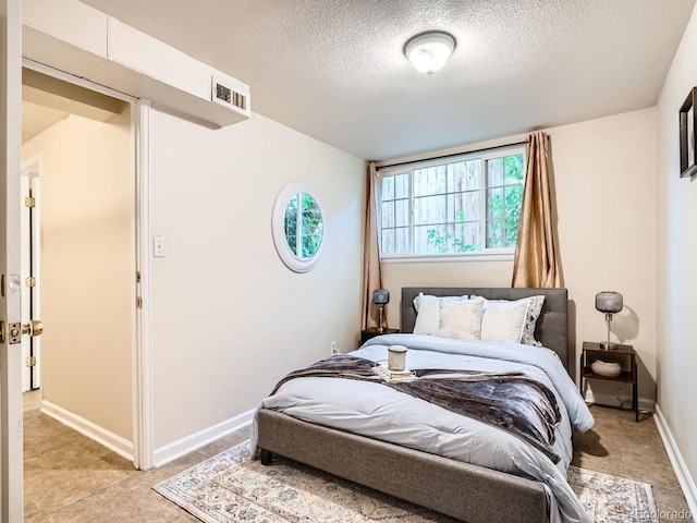 3304 W 3rd Ave, Denver, CO 80219 - bedroom with a textured ceiling and baseboards