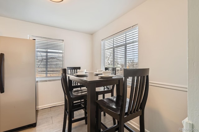 dining space featuring light tile patterned flooring