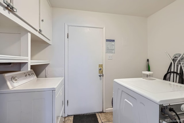 washroom with washer and dryer and cabinet space