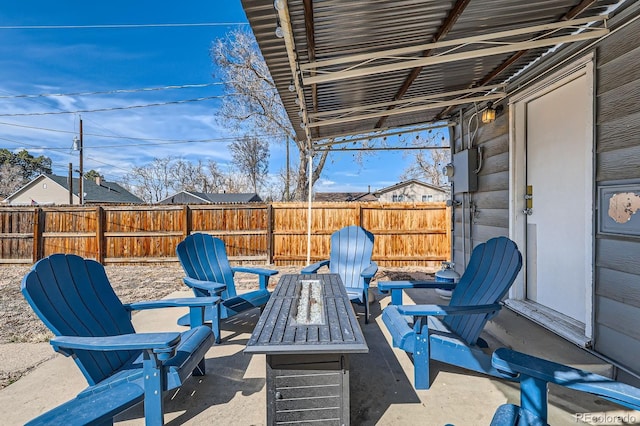 view of patio / terrace with a fire pit and fence