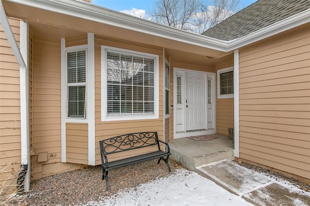 view of snow covered property entrance