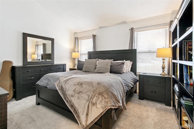 bedroom featuring vaulted ceiling, a textured ceiling, and light colored carpet