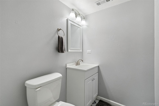 bathroom with toilet and vanity