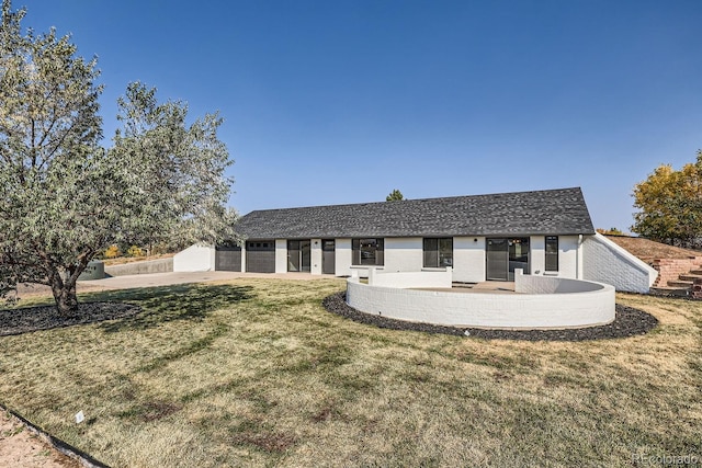 view of front of property with a front yard and a garage