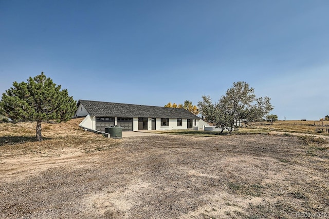 ranch-style home with a rural view