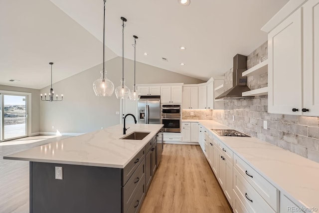 kitchen featuring white cabinets, a large island, appliances with stainless steel finishes, and hanging light fixtures