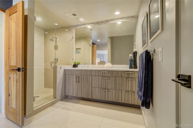 bathroom with tile patterned floors, a shower with shower door, and vanity