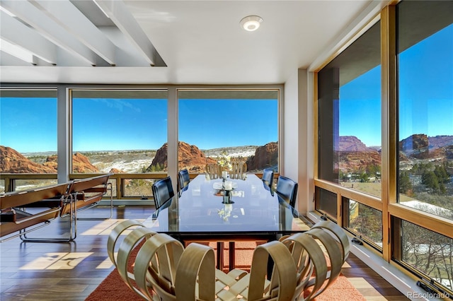 sunroom / solarium featuring a mountain view