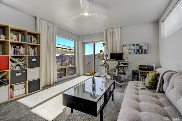 living room featuring carpet floors and ceiling fan