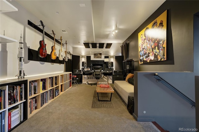 interior space featuring track lighting, carpet flooring, and a fireplace