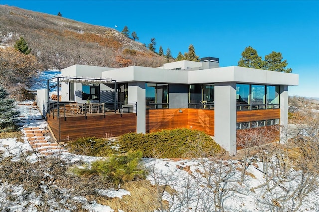 snow covered property featuring a mountain view