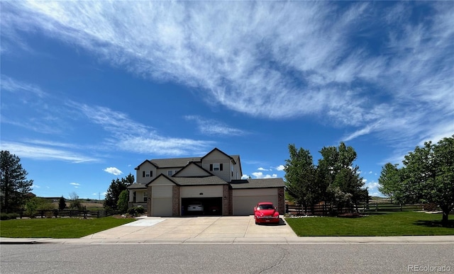 view of front of home featuring a front yard and a garage