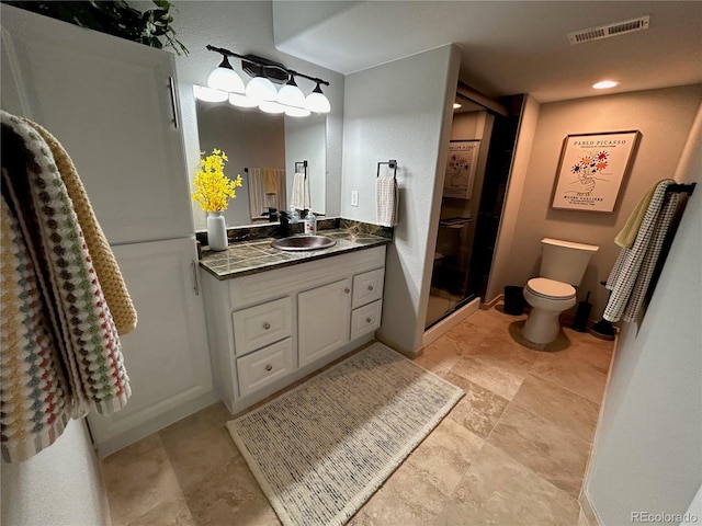 bathroom featuring vanity, toilet, and an enclosed shower