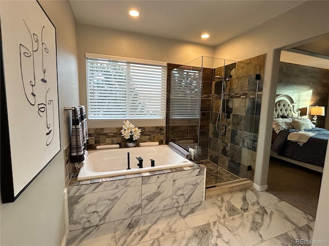 bathroom featuring separate shower and tub