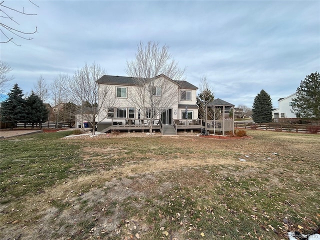 back of house featuring a yard and a wooden deck