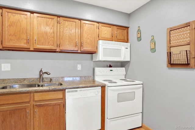 kitchen featuring white appliances and sink