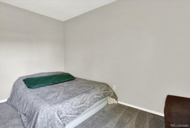 bedroom featuring dark colored carpet