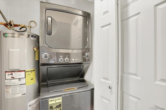 laundry area with water heater and stacked washer and clothes dryer