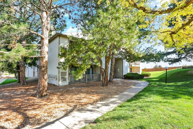 view of side of home with a yard