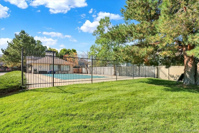 view of pool with a yard