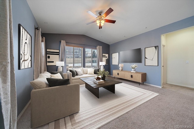 carpeted living room with ceiling fan and vaulted ceiling