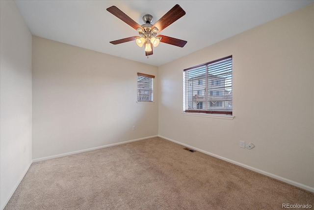 empty room with light carpet and ceiling fan