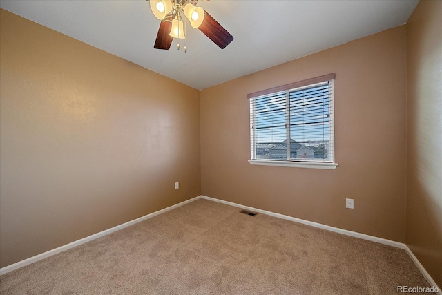 carpeted spare room featuring ceiling fan