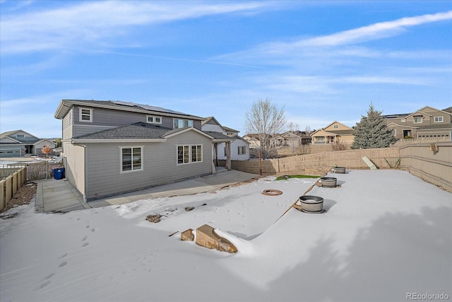 back of house with an outdoor fire pit