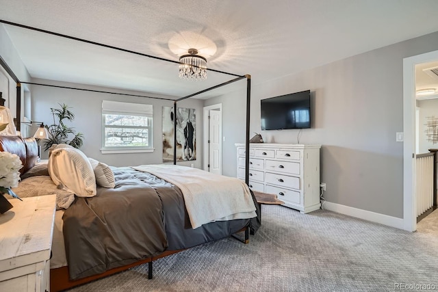 bedroom featuring baseboards, a textured ceiling, an inviting chandelier, and light colored carpet