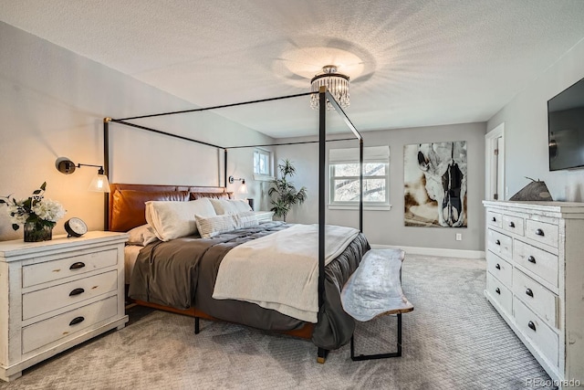 bedroom featuring light colored carpet, a notable chandelier, a textured ceiling, and baseboards