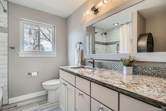 full bath featuring curtained shower, toilet, vanity, wood finished floors, and baseboards