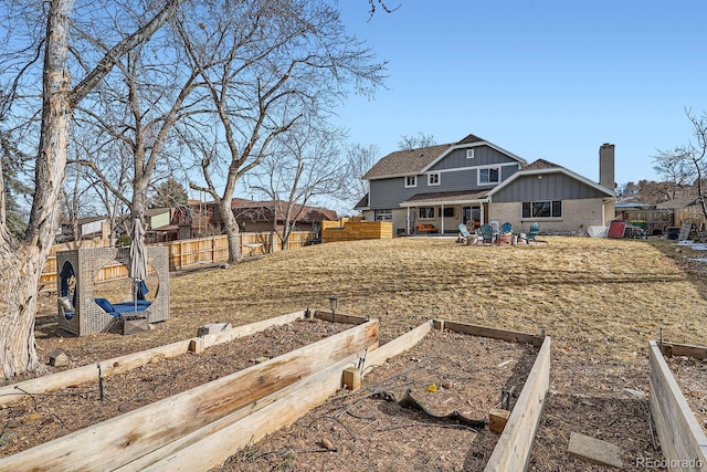 exterior space with board and batten siding and a fenced backyard