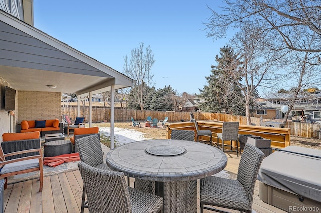 wooden deck with a fenced backyard, an outdoor hangout area, and outdoor dining space