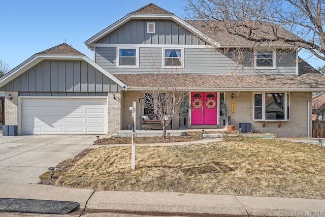 view of front of property with board and batten siding, brick siding, driveway, and an attached garage