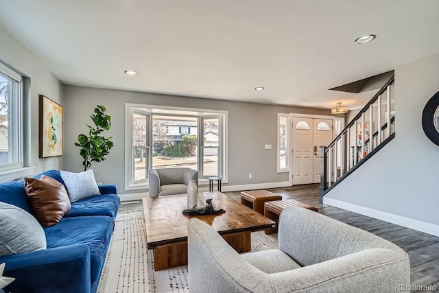 living room with recessed lighting, wood finished floors, baseboards, and stairs