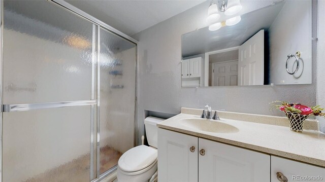 663 S Xenon Ct, Lakewood, CO 80228 - full bathroom featuring vanity and a stall shower