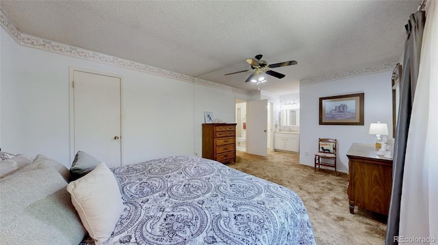 663 S Xenon Ct, Lakewood, CO 80228 - bedroom with light carpet, a textured ceiling, ensuite bath, and a ceiling fan