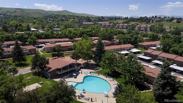663 S Xenon Ct, Lakewood, CO 80228 - aerial perspective of suburban area with mountains and a pool area