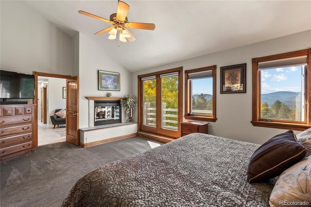 carpeted bedroom featuring baseboards, a ceiling fan, access to exterior, vaulted ceiling, and a multi sided fireplace