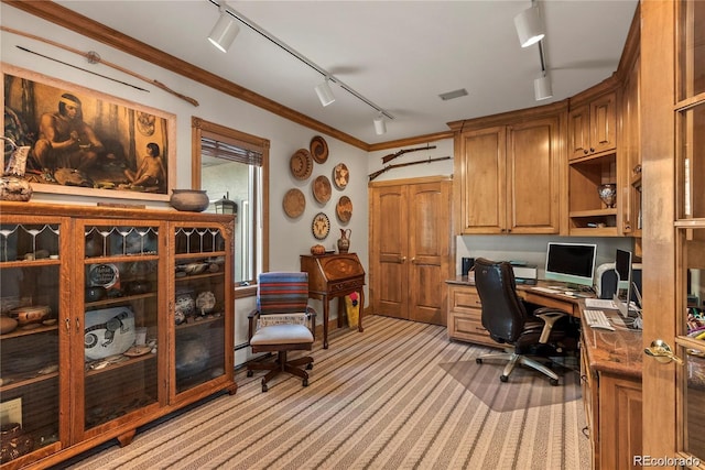 office space featuring built in desk, visible vents, ornamental molding, light carpet, and track lighting