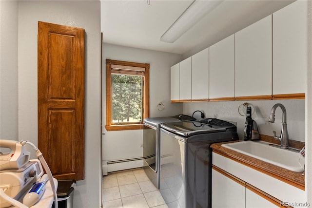 washroom featuring washer and clothes dryer, light tile patterned floors, cabinet space, baseboard heating, and a sink