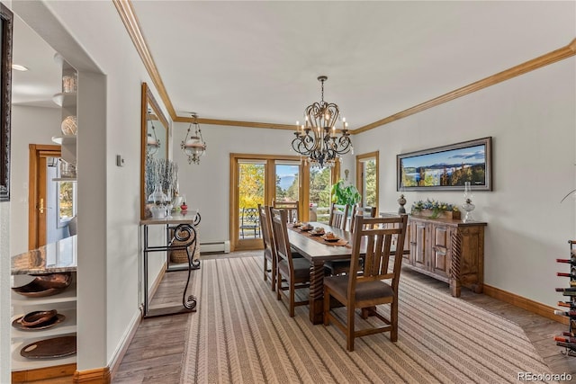 dining room with baseboard heating, crown molding, baseboards, and an inviting chandelier