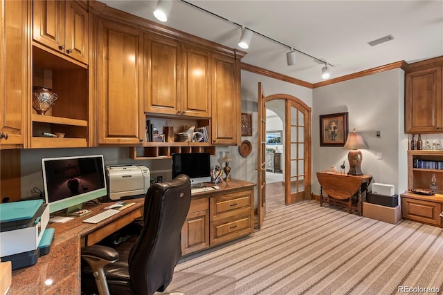 home office with visible vents, light colored carpet, ornamental molding, french doors, and built in desk