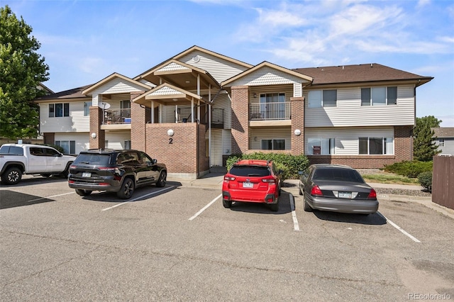 875 E 78th Ave Unit 9-2, Denver, CO 80229 - view of building exterior featuring uncovered parking