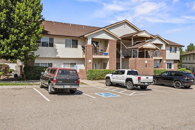 875 E 78th Ave Unit 9-2, Denver, CO 80229 - view of building exterior with uncovered parking