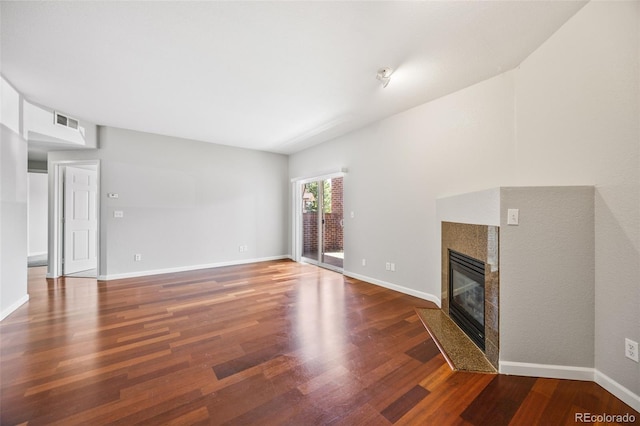 875 E 78th Ave Unit 9-2, Denver, CO 80229 - unfurnished living room featuring wood finished floors and a tiled fireplace