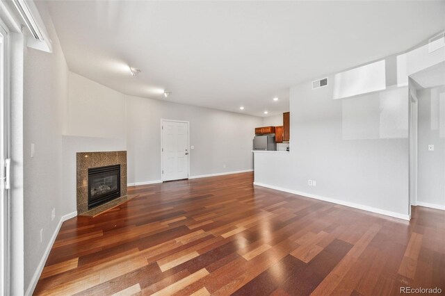 875 E 78th Ave Unit 9-2, Denver, CO 80229 - unfurnished living room with dark wood-style flooring, recessed lighting, and a fireplace