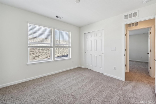 unfurnished bedroom with a closet and carpet